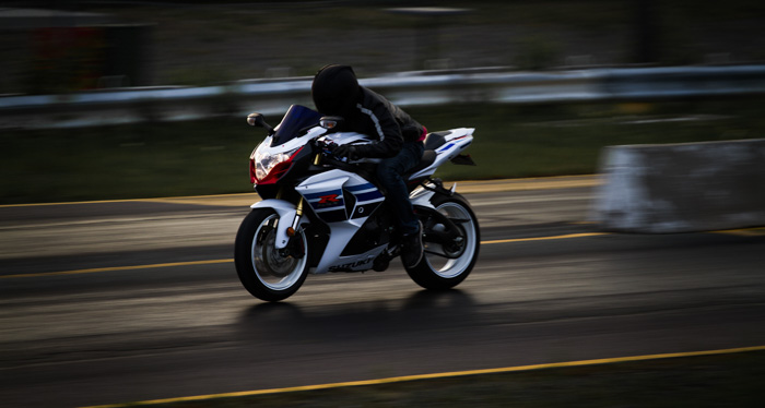 摩托车竟赛者的高速照片在低光的轨道的