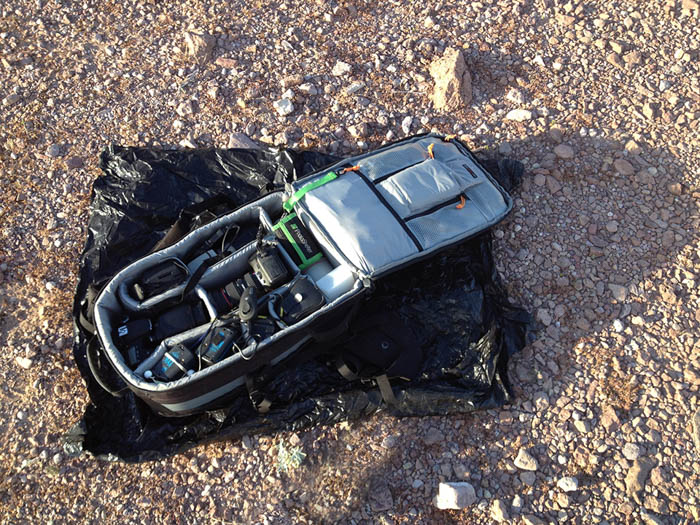 沙漠摄影时用垃圾袋保护相机的照片