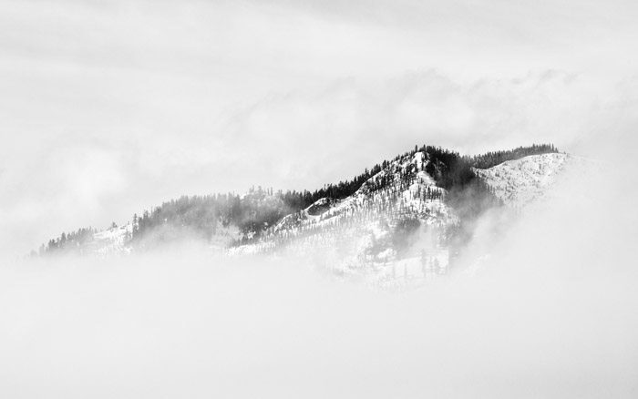 Atmospheric misty and snowy mountainous landscape - tone and weight balance in photography