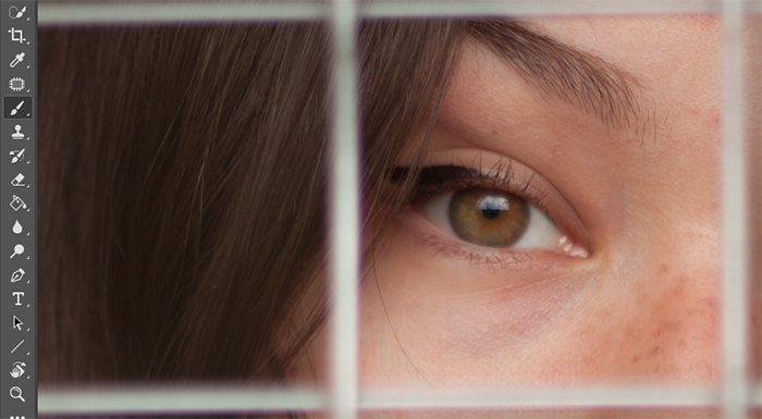 一个女孩的眼睛的特写，在她的面前有一个栅栏打开编辑